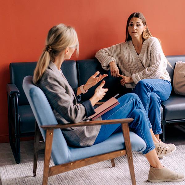 Mental health & counseling Two women talking in a counseling room – symbol of mental health and support.”
